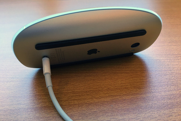 Wanna use Apple's Magic Mouse while charging it? TOO DAMN BAD. Photo by Roman Loyola; via Macworld.