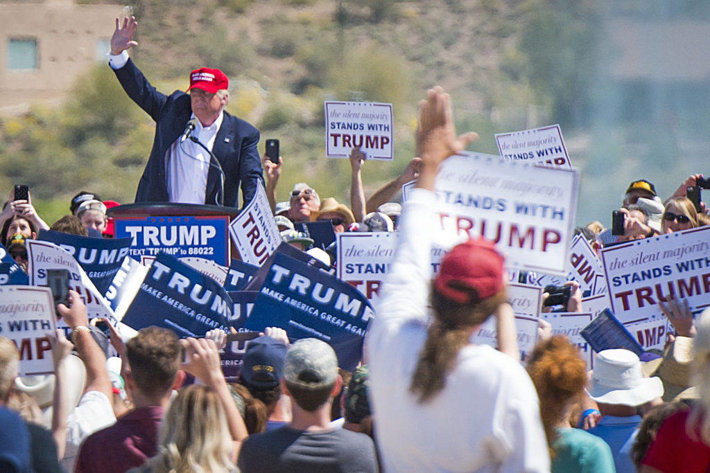 Donald Trump waving to supporters at a rally. Photo by Ed Ouimette.